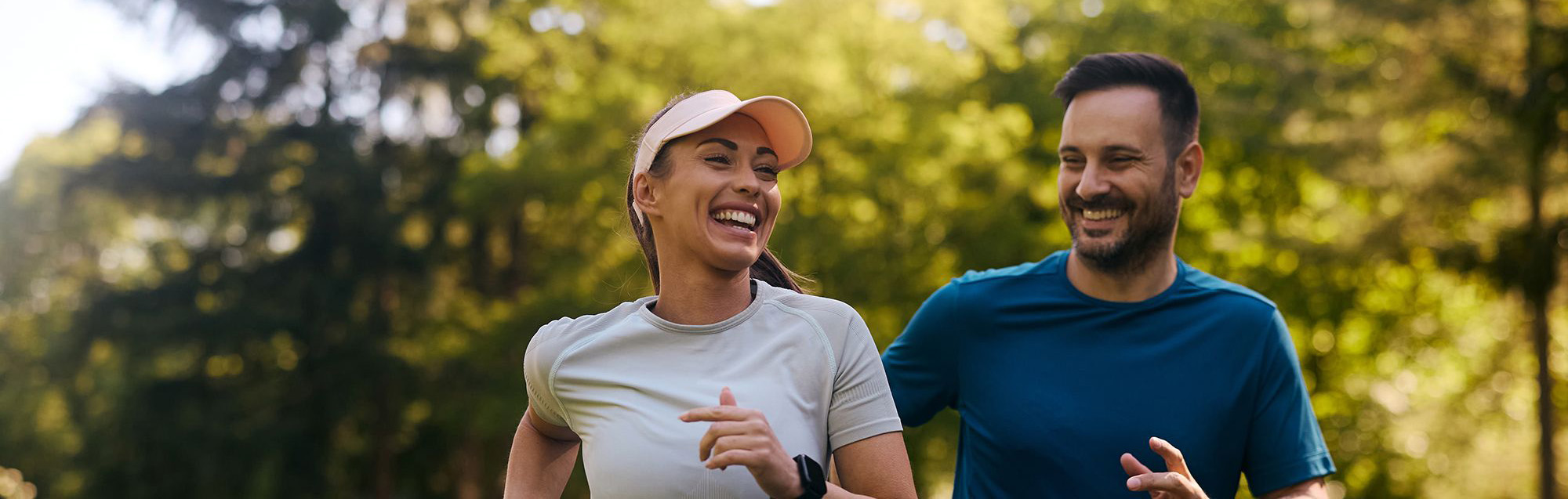 A couple smiling and running at the same time, but don't worry they're running responsibly 